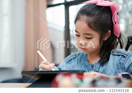 A young girl is playing with a remote control a robot 113143138