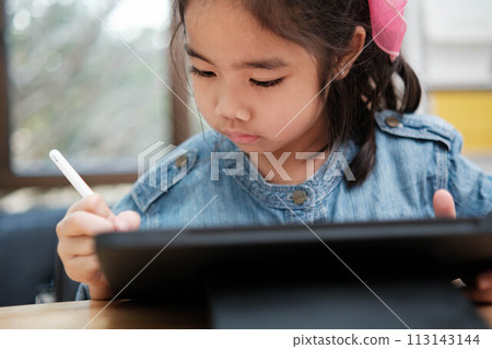 A young girl is playing with a remote control a robot 113143144