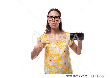 young pretty caucasian woman in a yellow summer t-shirt carefully shows a smartphone with a young pretty caucasian woman in a yellow summer t-shirt carefully shows a smartphone with a 113143898