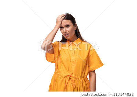 young caucasian brunette woman with long hair dressed in a yellow summer dress is trying to remember 113144028