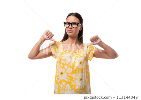 young serious brunette woman with glasses dressed in a summer orange T-shirt points at herself with young serious brunette woman with glasses dressed in a summer orange T-shirt points at herself with 113144049