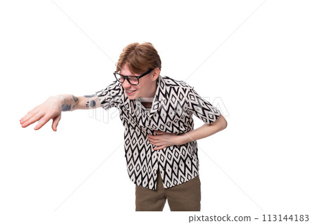 young handsome red-haired guy in glasses dressed in a summer shirt laughs loudly at a joke young handsome red-haired guy in glasses dressed in a summer shirt laughs loudly at a joke 113144183