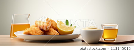 Crispy golden nuggets with savory dipping sauce and fresh lemon wedge on white background. Banner 113145015