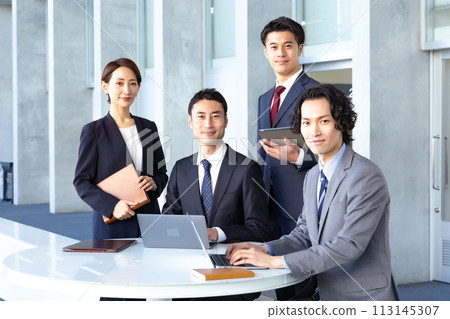 Business men and women looking at camera Business men and women looking at camera 113145307
