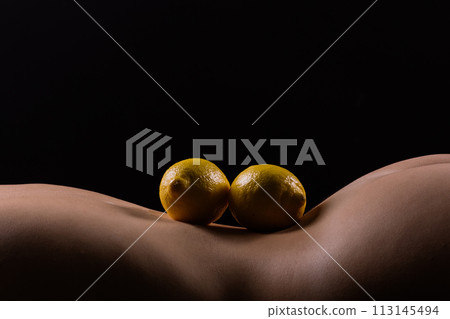 Lemon, natural vitamin c help skin whitening. Naked woman lying on her back with fruit located Lemon, natural vitamin c help skin whitening. Naked woman lying on her back with fruit located 113145494
