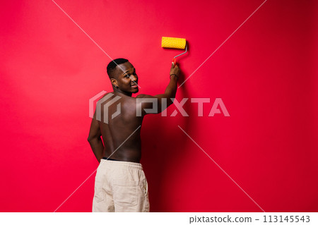 African-American painter on red studio background topless 113145543