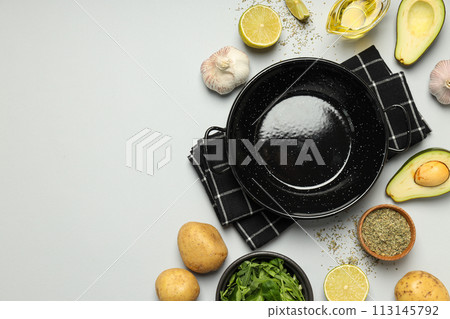 A pan for cooking on the table, with ingredients. 113145792