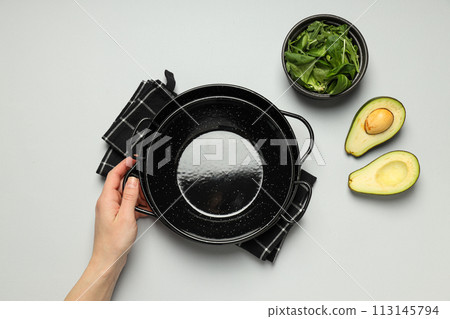 A pan for cooking on the table, with ingredients. 113145794