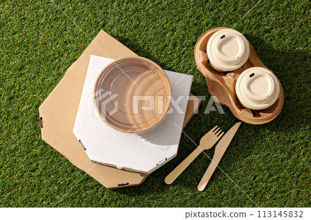 Ecological packaging for food delivery, on the grass. Ecological packaging for food delivery, on the grass. 113145832
