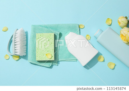 Washcloth, brush and detergents with fresh flowers 113145874