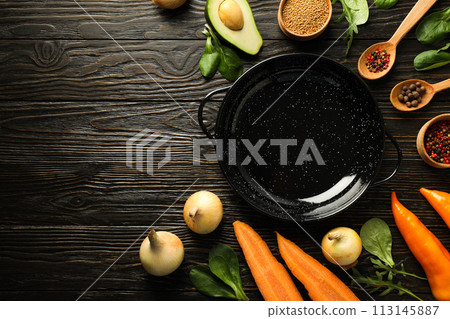 A pan for cooking on the table, with ingredients. A pan for cooking on the table, with ingredients. 113145887