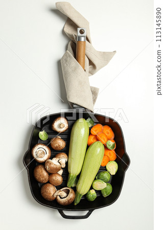 A pan for cooking on the table, with ingredients. 113145890