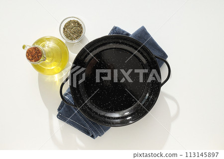 A pan for cooking on the table, with ingredients. 113145897