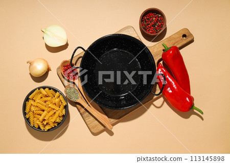A pan for cooking on the table, with ingredients. A pan for cooking on the table, with ingredients. 113145898