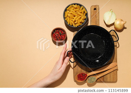 A pan for cooking on the table, with ingredients. A pan for cooking on the table, with ingredients. 113145899