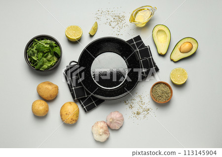 A pan for cooking on the table, with ingredients. A pan for cooking on the table, with ingredients. 113145904