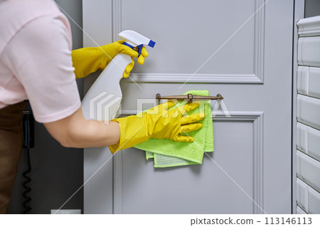 Close-up hands in protective gloves cleaning bathroom, facades of furniture Close-up hands in protective gloves cleaning bathroom, facades of furniture 113146113