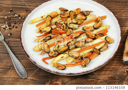 Roasted mussels with asparagus, salad. 113146339