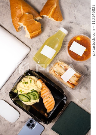 Top view of delicious lunch with laptop on table 113146822