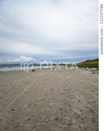 20 man are competing in a fishing competition on the beach. 20 man are competing in a fishing competition on the beach. 113147588