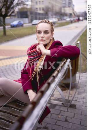 portrait of a stylish middle-aged woman with braids on a spring street portrait of a stylish middle-aged woman with braids on a spring street 113147765