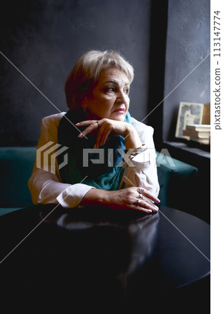 portrait of an old woman in a cafe 113147774