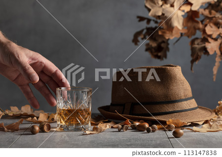 Whiskey in crystal glass on a grey stone table. 113147838