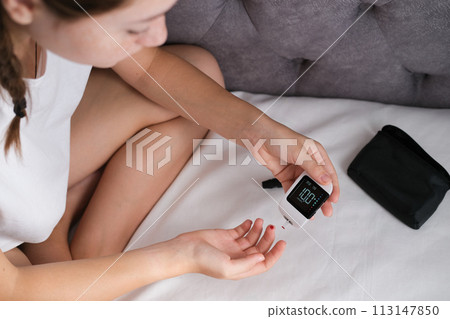 Diabetes test. Child hands checking blood sugar level by Glucose meter. Diabetes test. Child hands checking blood sugar level by Glucose meter. 113147850