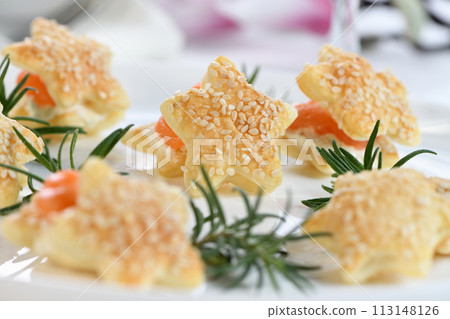 Puff pastry stars with salmon and cheese Puff pastry stars with salmon and cheese 113148126
