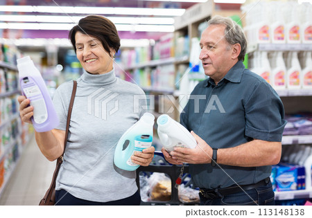 Mature couple choosing laundry detergent in supermarket Mature couple choosing laundry detergent in supermarket 113148138