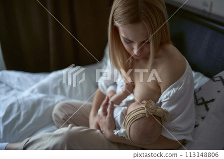 Caucasian mother brestfeed her child 113148806