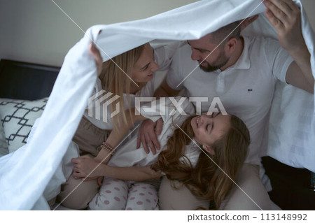 parents play with their daughter 113148992