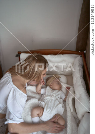 parents comfort their child in a cradle parents comfort their child in a cradle 113149013
