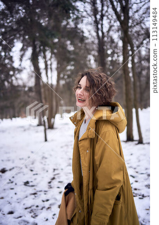 woman in yellow coat in the forest 113149484