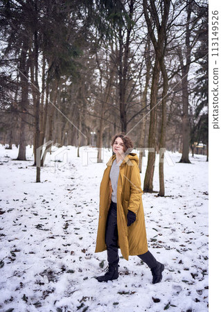 woman in yellow coat in the forest 113149526