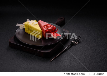 Delicious sweet cheesecake with fruits covered with icing with a wooden stick 113150884