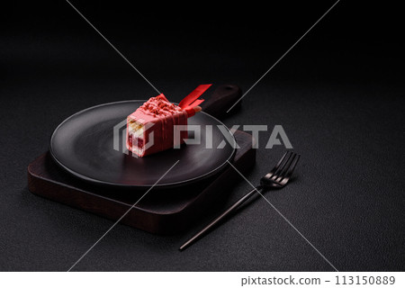 Delicious sweet cheesecake with fruits covered with icing with a wooden stick 113150889