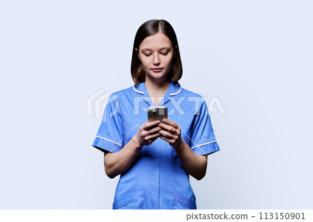Young female nurse using smartphone, on white background Young female nurse using smartphone, on white background 113150901