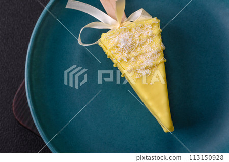 Delicious sweet cheesecake with fruits covered with icing with a wooden stick 113150928