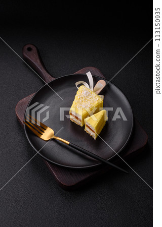 Delicious sweet cheesecake with fruits covered with icing with a wooden stick 113150935