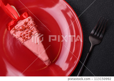 Delicious sweet cheesecake with fruits covered with icing with a wooden stick 113150992