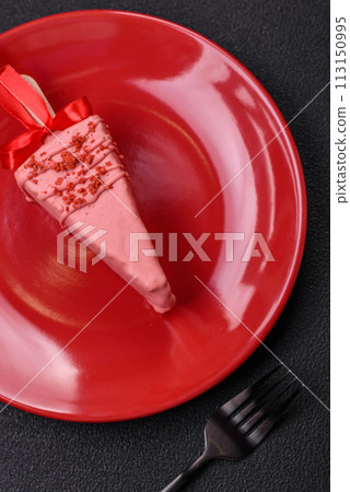 Delicious sweet cheesecake with fruits covered with icing with a wooden stick Delicious sweet cheesecake with fruits covered with icing with a wooden stick 113150995