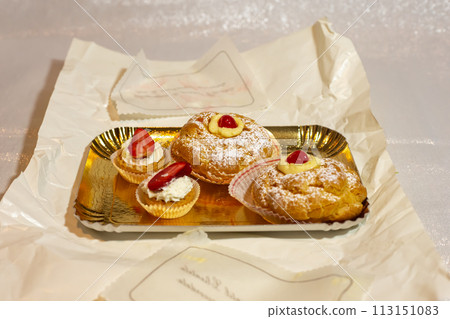 Italian dessert Zeppole di San Giuseppe, zeppola baked puffs made from choux pastry 113151083