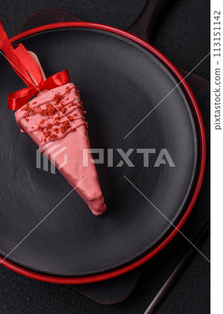 Delicious sweet cheesecake with fruits covered with icing with a wooden stick Delicious sweet cheesecake with fruits covered with icing with a wooden stick 113151142