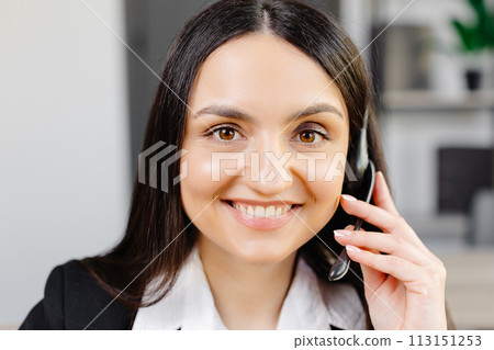 Call center agent with headset working on support hotline in modern office. Video conference. Call center agent with headset working on support hotline in modern office. Video conference. 113151253