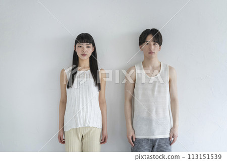 young man and woman looking at camera 113151539