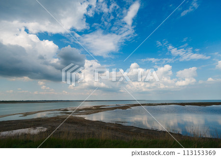 Sky and big clouds over firth with horizon line Sky and big clouds over firth with horizon line 113153369
