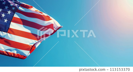 American flag waving against a clear blue sky. American flag waving against a clear blue sky. 113153370