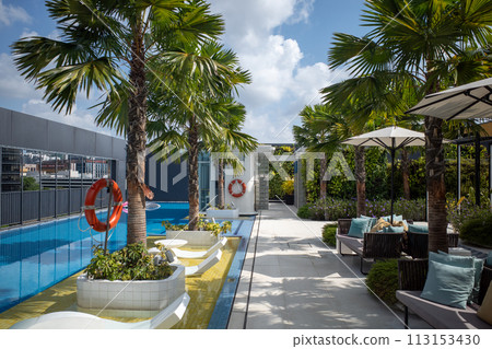 Parasol placed by the pool 113153430