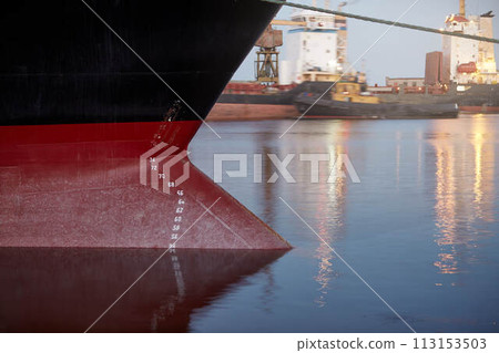 Draft marks on a ship - waterline numbers on bow and stern of a vessel at seaport in the evening 113153503